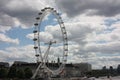 The london eye on the river under a gray and cloudy spring sky