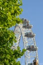 The London Eye seen against a blue sky.