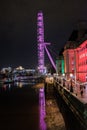 The London Eye side profile. Purple light illuminating the Eye and near by structures lit by lights.