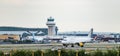 A Vueling Airlines S.A. Airbus A319-100 turns off the runway in front of the air traffic control tower