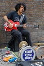 Guitarist playing in Brick Lane