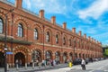 Historical facade of the station St. Pancras in London with passengers in the foreground