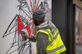 London, January 26, 2020. Professional painter at work, painting a street wall.Young man painting the wall, street art in process