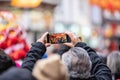 London, January 26, 2020. Spectators taking pictures with cell phones during Chinese New Year Celebrations Royalty Free Stock Photo