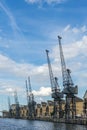 LONDON - JUNE 25 : Old dockside cranes alongside a waterfront de Royalty Free Stock Photo