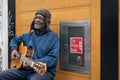 LONDON - MARCH 3, 2020: elderly black man playing guitar on a city street