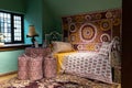 Liberty`s, Luxury department store. Interior with a bed, a red patchwork bedspread, pillows and a