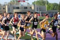 Editorial photo of a large group of competitive runners running on a track, London Ontario