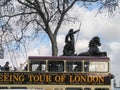 London Open-top Sightseeing Bus Tour moving near Boadicea statue chariot