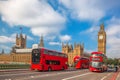 London with red buses against Big Ben in England, UK