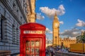 London with red phone booth against Big Ben in England, UK Royalty Free Stock Photo