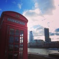 London red phone box, with building and blue sky Royalty Free Stock Photo