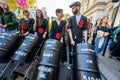 Climate Change protesters with face paint and pushing oil barrels in strollers at an Extinction Rebellion march