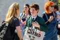 Young schoolboy in school uniform explaining the climate change issues to a woman at an Extinction Rebellion protest march