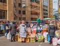 A London street market trader selling on top of his stall