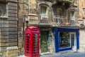 London-style iconic red phone box standing next to run-down old building in Valletta, Royalty Free Stock Photo