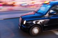 London taxi in motion blur at night Royalty Free Stock Photo