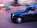 London taxi in motion blur at night Royalty Free Stock Photo