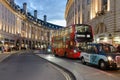 London taxi and red double decker bus on Regent Street at dusk Royalty Free Stock Photo