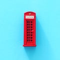 London traditional red phone booth over blue background