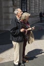 London, U.K. August 22, 2019 - Mature, senior attractive couple on vacation looking at a map on London street