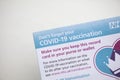 LONDON, UK - APRIL 2021. Close up of a NHS Covid-19 vaccination record card Royalty Free Stock Photo