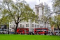 London, UK - April 2018: Double-decker buses and Middlesex Guildhall home of Supreme Court and Judicial Committee of Privy Counci