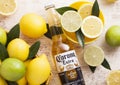 LONDON, UK - APRIL 27, 2018: Glass Bottle of Corona Extra Beer on wooden background with fresh lemons and limes. Royalty Free Stock Photo