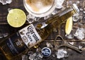 LONDON, UK - APRIL 27, 2018: Glass Bottle of Corona Extra Beer on wooden background with bottle opener and ice cubes and glass of Royalty Free Stock Photo