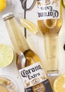 LONDON, UK - APRIL 27, 2018: Glass Bottles of Corona Extra Beer on light wooden background with bottle opener and glass of beer.To Royalty Free Stock Photo