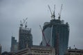 LONDON, UK - APRIL 9, 2013: London Business District Onder Construction. Cranes on the roofs. Late evening photo shoot Royalty Free Stock Photo