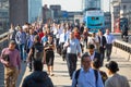 Office workers crossing the London bridge in early morning on the way to the City of London, UK Royalty Free Stock Photo