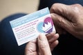 LONDON, UK - APRIL 2021. A person holding NHS Covid-19 vaccination record card Royalty Free Stock Photo