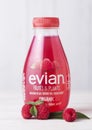 LONDON, UK - APRIL 27, 2018: Plastic bottle of Evian pure still water with raspberry on wooden background with raw fruits. Royalty Free Stock Photo