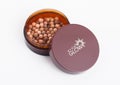 LONDON, UK - APRIL 27, 2018: Plastic container of Avon Glow Bronzing Pearls on white background.