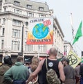 London, UK, April 17 2019 - Protesters hold a banner and flag at a climate change protest outside Oxford Circus underground Royalty Free Stock Photo