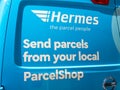 Hermes blue courier van with logo and parcelshop signage.