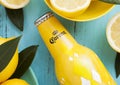 LONDON, UK - APRIL 27, 2018: Steel Bottle of Corona Extra Beer on blue wooden background with fresh lemons. Royalty Free Stock Photo