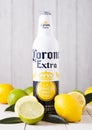 LONDON, UK - APRIL 27, 2018: Steel Bottle of Corona Extra Beer on wooden background with fresh lemons and limes. Royalty Free Stock Photo