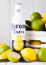 LONDON, UK - APRIL 27, 2018: Steel Bottle of Corona Extra Beer on wooden background with fresh lemons and limes in wooden box. Royalty Free Stock Photo
