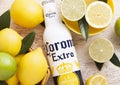 LONDON, UK - APRIL 27, 2018: Steel Bottle of Corona Extra Beer on wooden background with fresh lemons Royalty Free Stock Photo