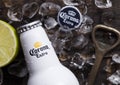 LONDON, UK - APRIL 27, 2018: Steel Bottle of Corona Extra Beer on wooden background with bottle opener and ice cubes.Top view Royalty Free Stock Photo