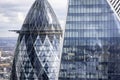 London, UK - April 12th 2021: closeup detail view to the modern glass facade of the Gherkin and Scalpel office buildings Royalty Free Stock Photo