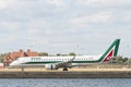 Alitalia regional airplane taxiing at London City Airport after landing