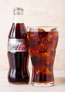 LONDON, UK - AUGUST 03, 2018: Glass bottle and original glass of Diet Coke Coca Cola soft drink on wooden background. Most popular