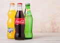 LONDON, UK - AUGUST 03, 2018: Glass bottles of Coca Cola and Fanta and Sprite soft drink on wooden background. Most popular drinks