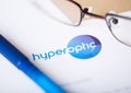 LONDON, UK - AUGUST 18, 2018: Hyper Optic broadband logo with glasses and blue pen.