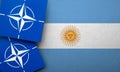 LONDON, UK - August 2022: NATO North Atlantic Treaty Organization military alliance logo on a Argentina flag