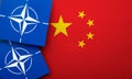 LONDON, UK - August 2022: NATO North Atlantic Treaty Organization military alliance logo on a China flag