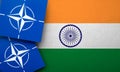 LONDON, UK - August 2022: NATO North Atlantic Treaty Organization military alliance logo on a India flag